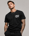 Man wearing a black t-shirt with 'DRUM CLUB' text on a gray background